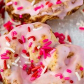 heart shaped cinnamon roll with pink icing and sprinkles