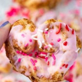 heart shaped cinnamon roll with pink icing and sprinkles