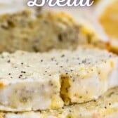 Close up shot of lemon poppyseed bread slices on cooling rack with recipe title on top of image