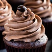 Three chocolate cupcakes topped with mocha frosting and a chocolate covered coffee bean with recipe title on top of image