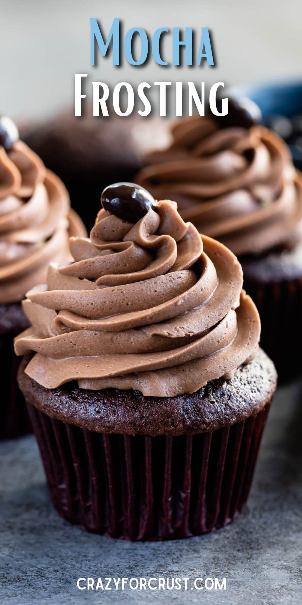 Three chocolate cupcakes topped with mocha frosting and a chocolate covered coffee bean with recipe title on top of image