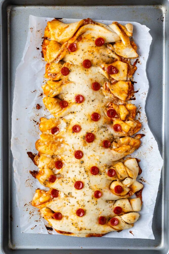 Overhead shot of twisted pepperoni pizza on a sheet pan