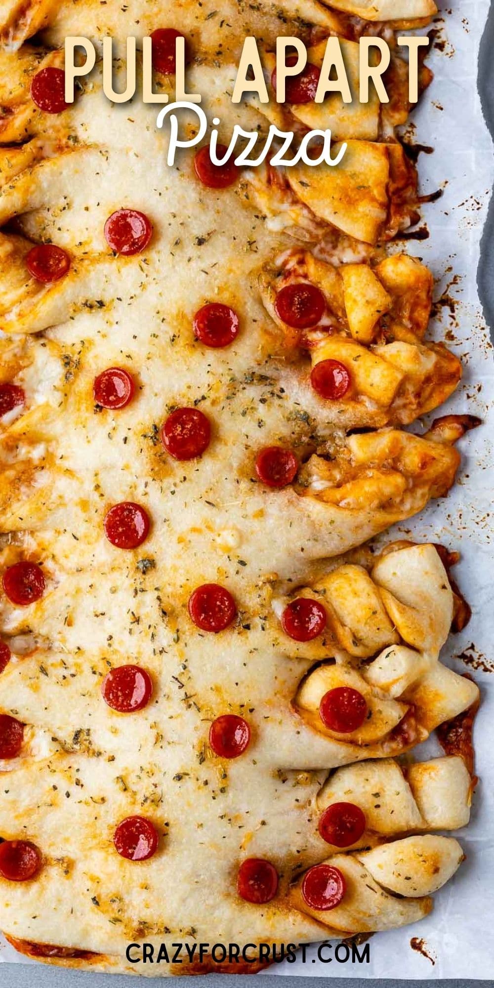 Overhead shot of pull apart pepperoni pizza on a sheet pan with recipe title on top of image