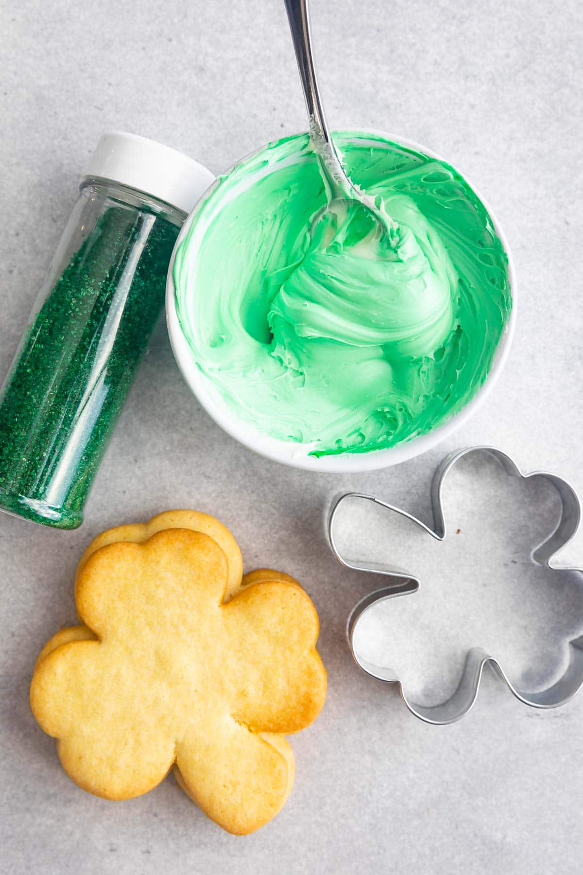 Overhead shot of everything needed to make sugar shamrock cookies