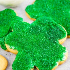 Close up shot of shamrock sugar cookies decorated with green sanding sugar