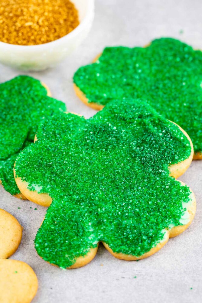 Close up shot of shamrock sugar cookies decorated with green sanding sugar