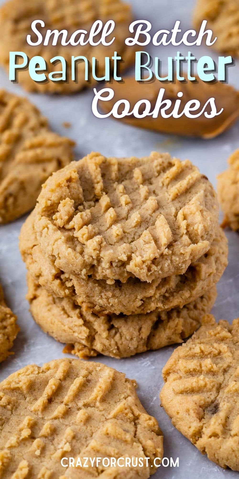 Peanut butter cookies on parchment paper with recipe title on top of image