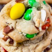 Stack of almond chocolate chip cookies with recipe title on top of image