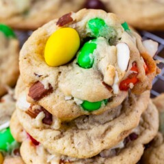 Stack of almond chocolate chip cookies on a metal cooling rack