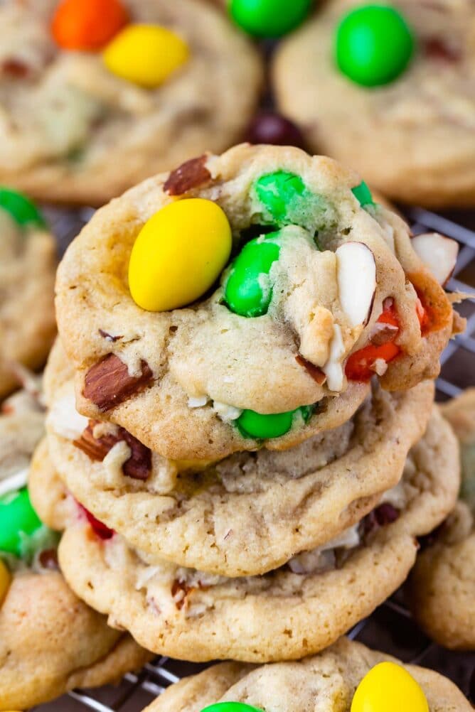 Stack of almond chocolate chip cookies on a metal cooling rack