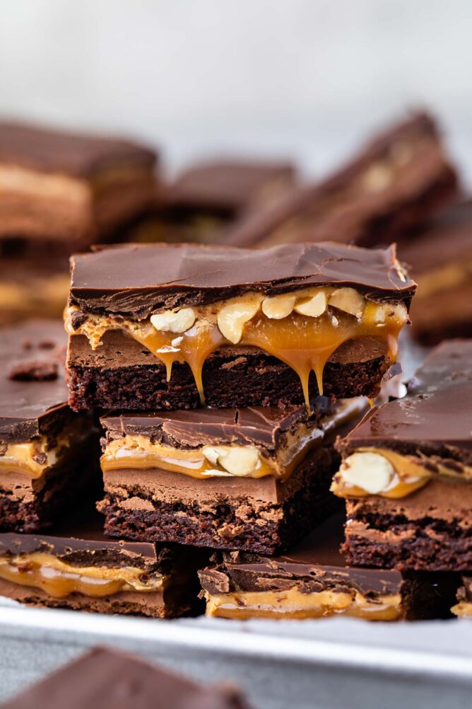 Snickers Brownies stacked on a plate