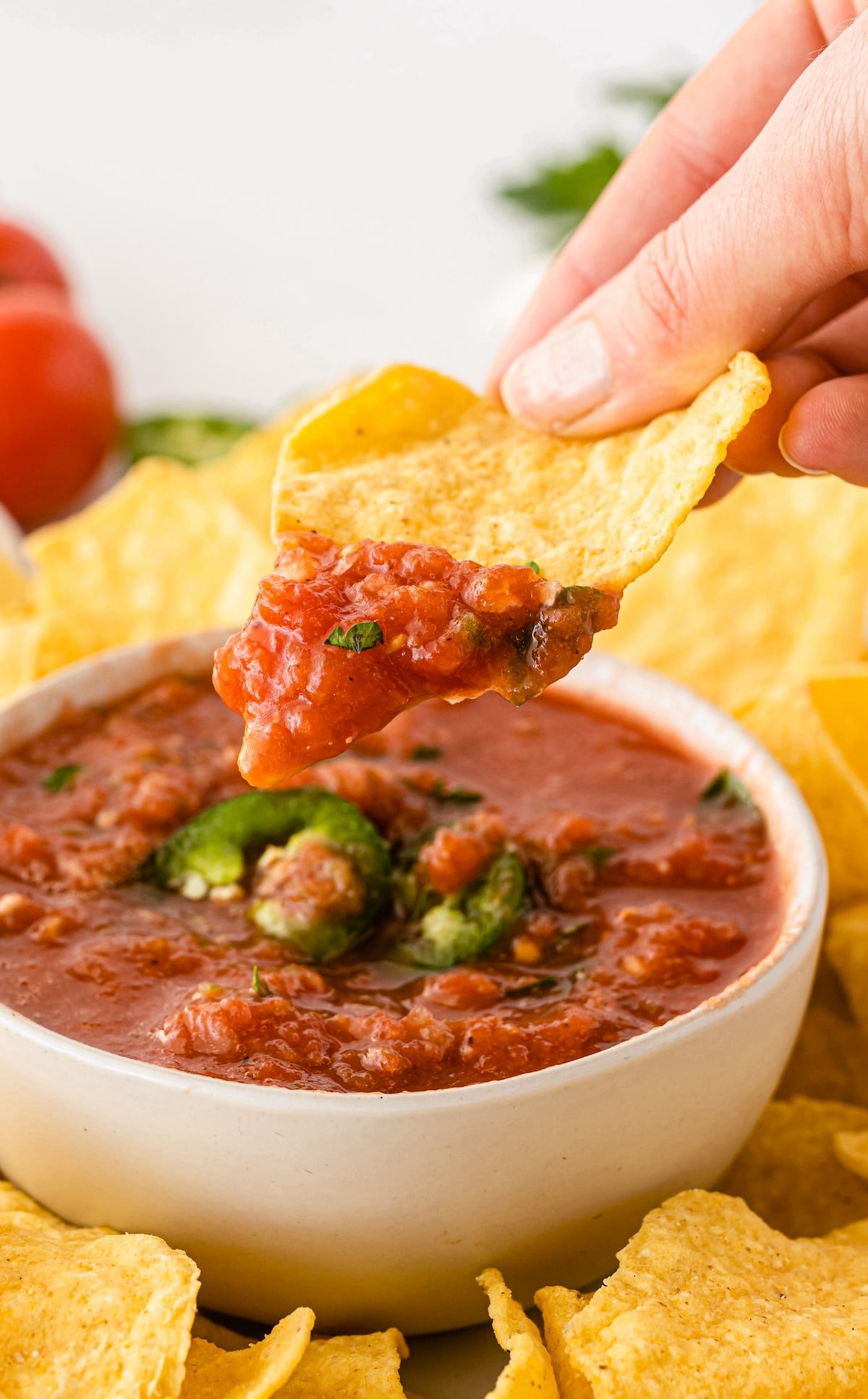 Chip being dipped into a bowl of easy salsa