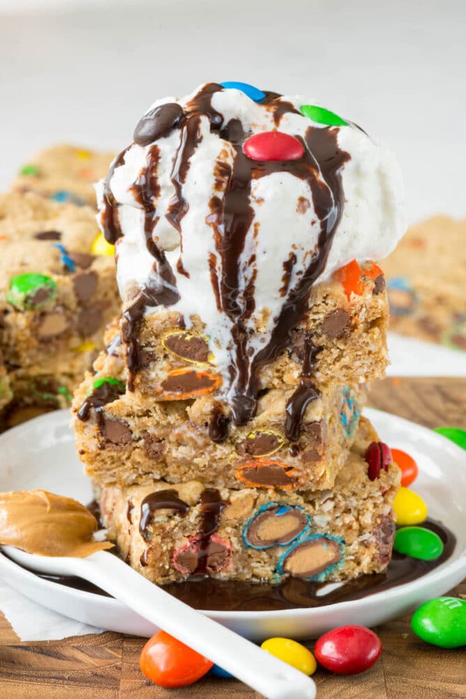 stack of cookie bars on white plate with M&Ms and Ala mode