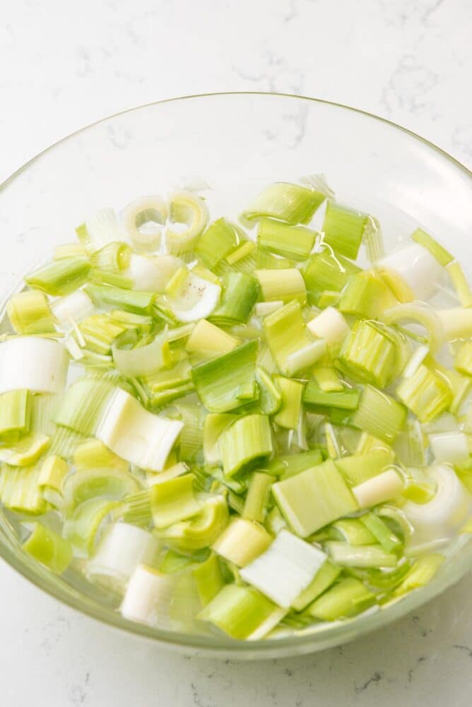 Leeks soaking in a large bowl of water