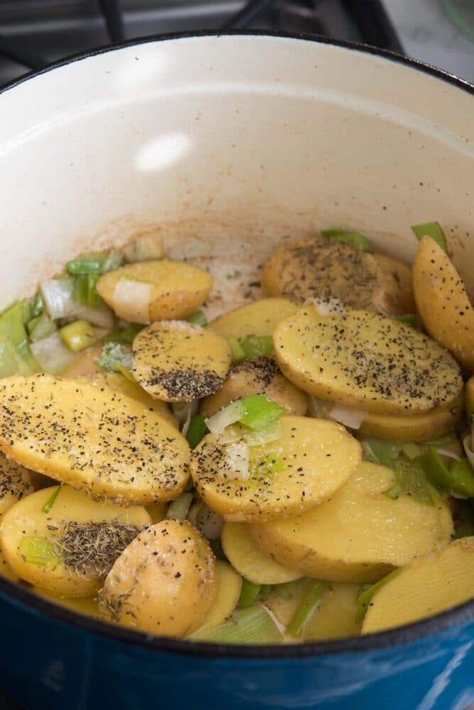 Potato and leeks in the dutch oven being cooked down