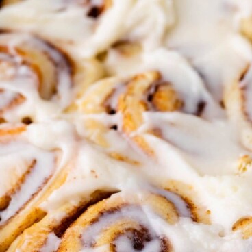 cinnamon rolls in pan with words on photo