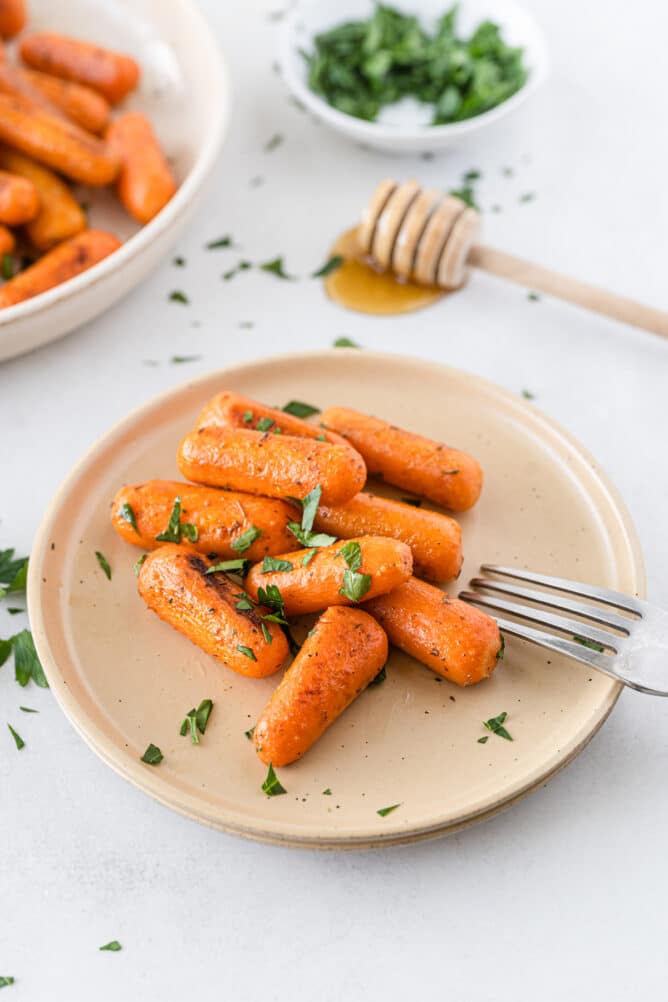 Small plate filled with roasted carrots topped with parsley