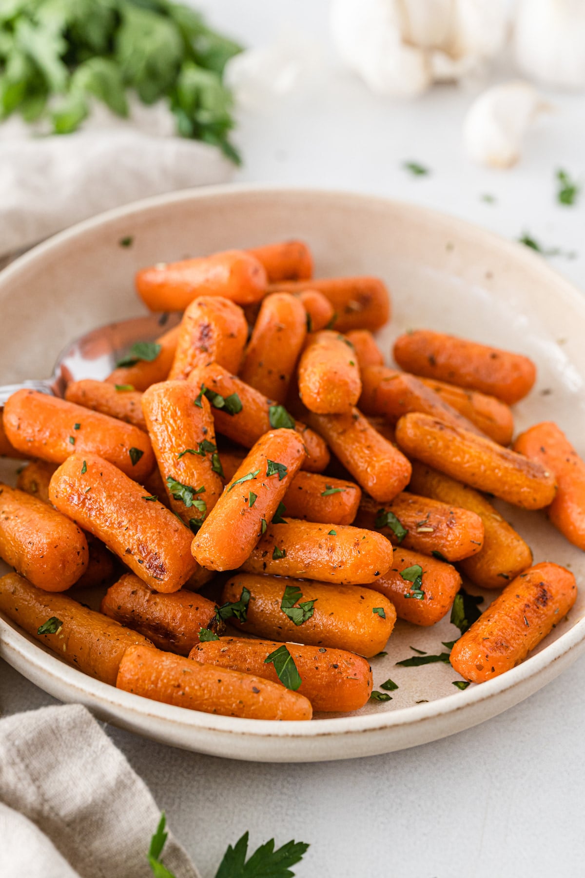 Roasted carrots in a white serving bowl