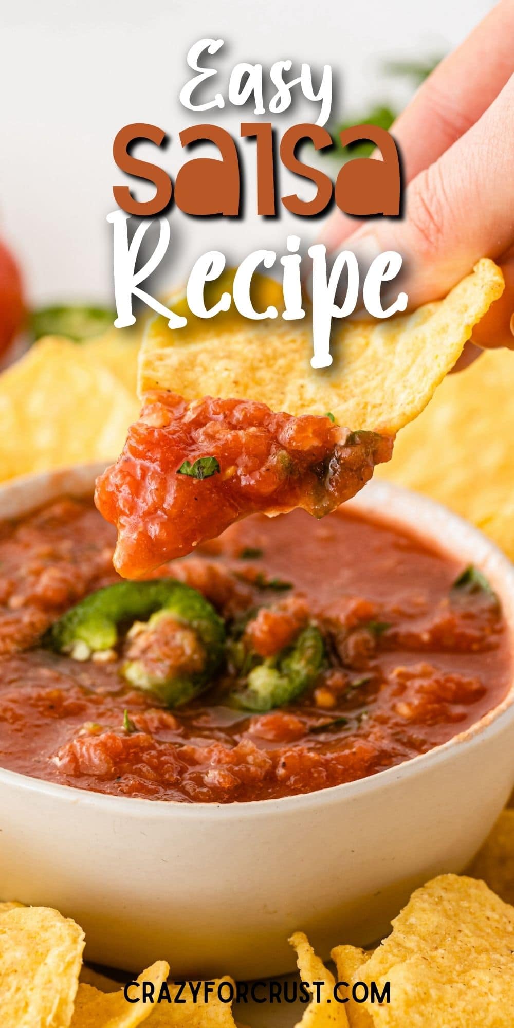 Chip being dipped into a bowl of easy salsa with recipe title on top of image