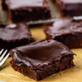 A bunch of double fudge brownies on parchment paper