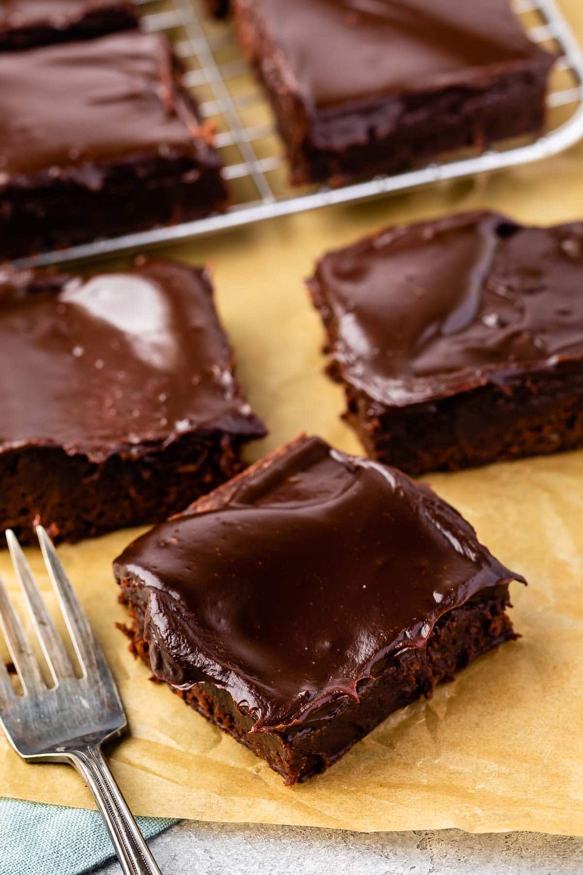 Overhead shot of double fudge brownies cut into squares on parchment paper