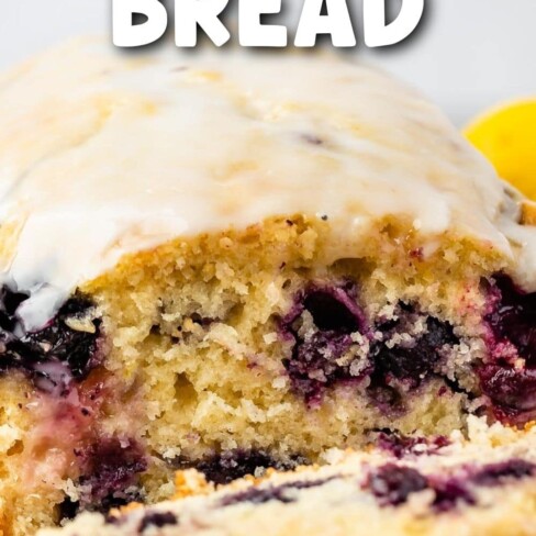 Lemon blueberry loaf with one slice cut off and recipe title on top of image