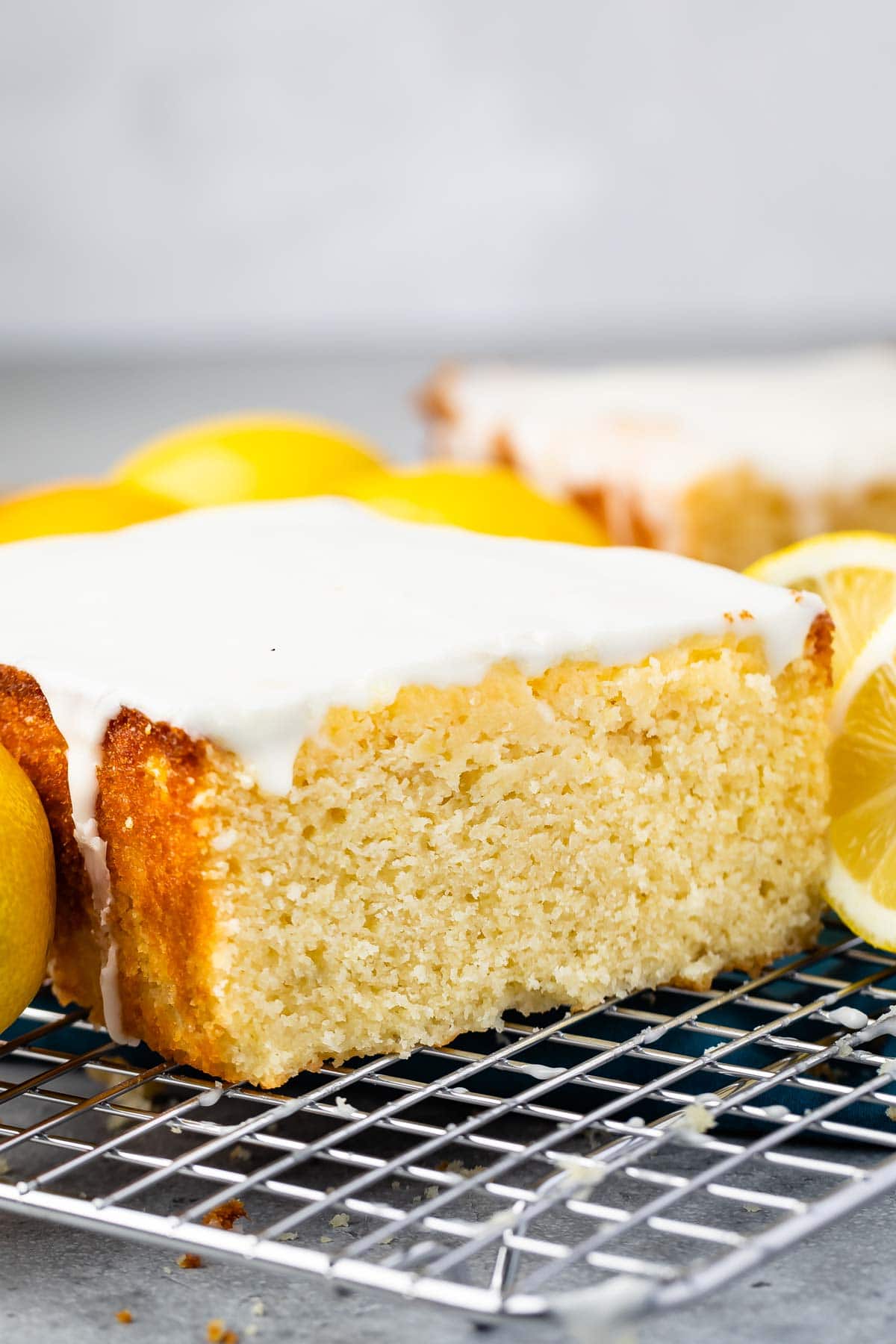 Lemon pound cake topped with glaze on a metal wire rack