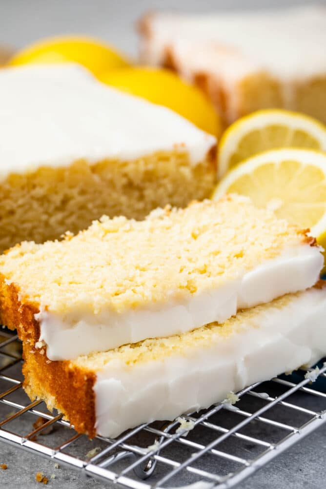 Lemon pound cake with two slices cut off on a metal wire rack