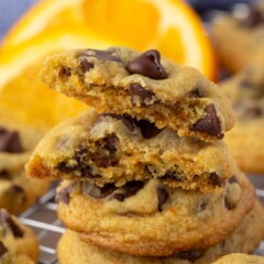 Stack of chocolate chip orange cookies with top one split in half to show inside