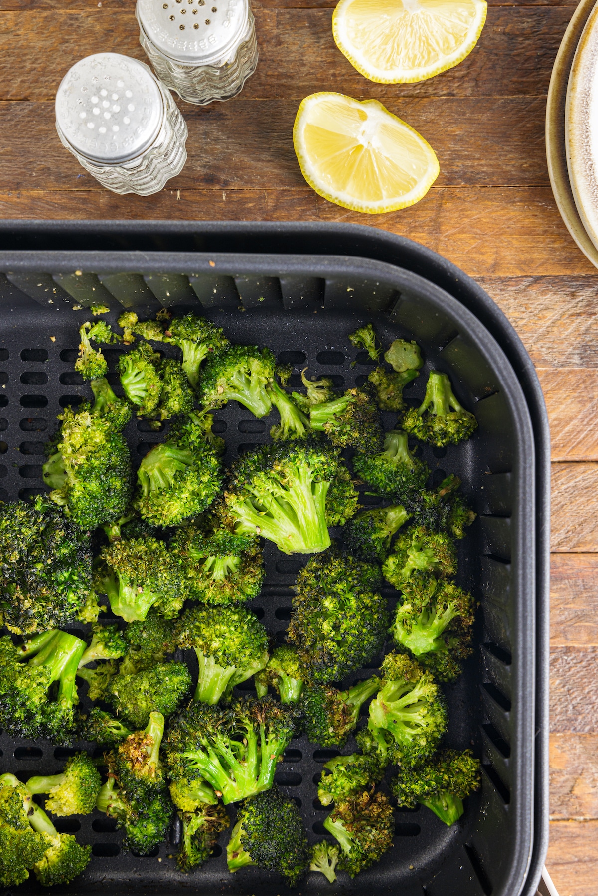 Close up overhead shot of broccoli after being cooked in the air fryer tray