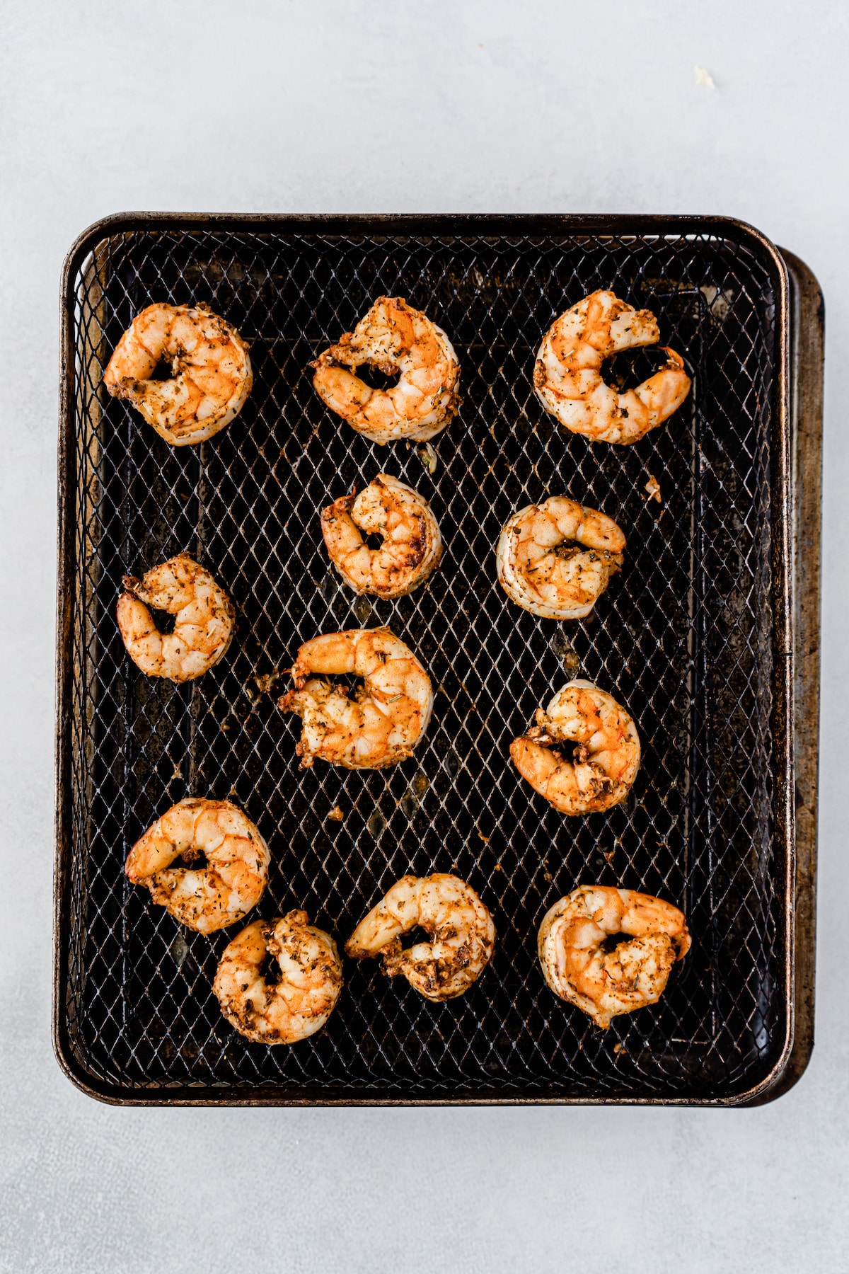 Cooked shrimp on air fryer tray