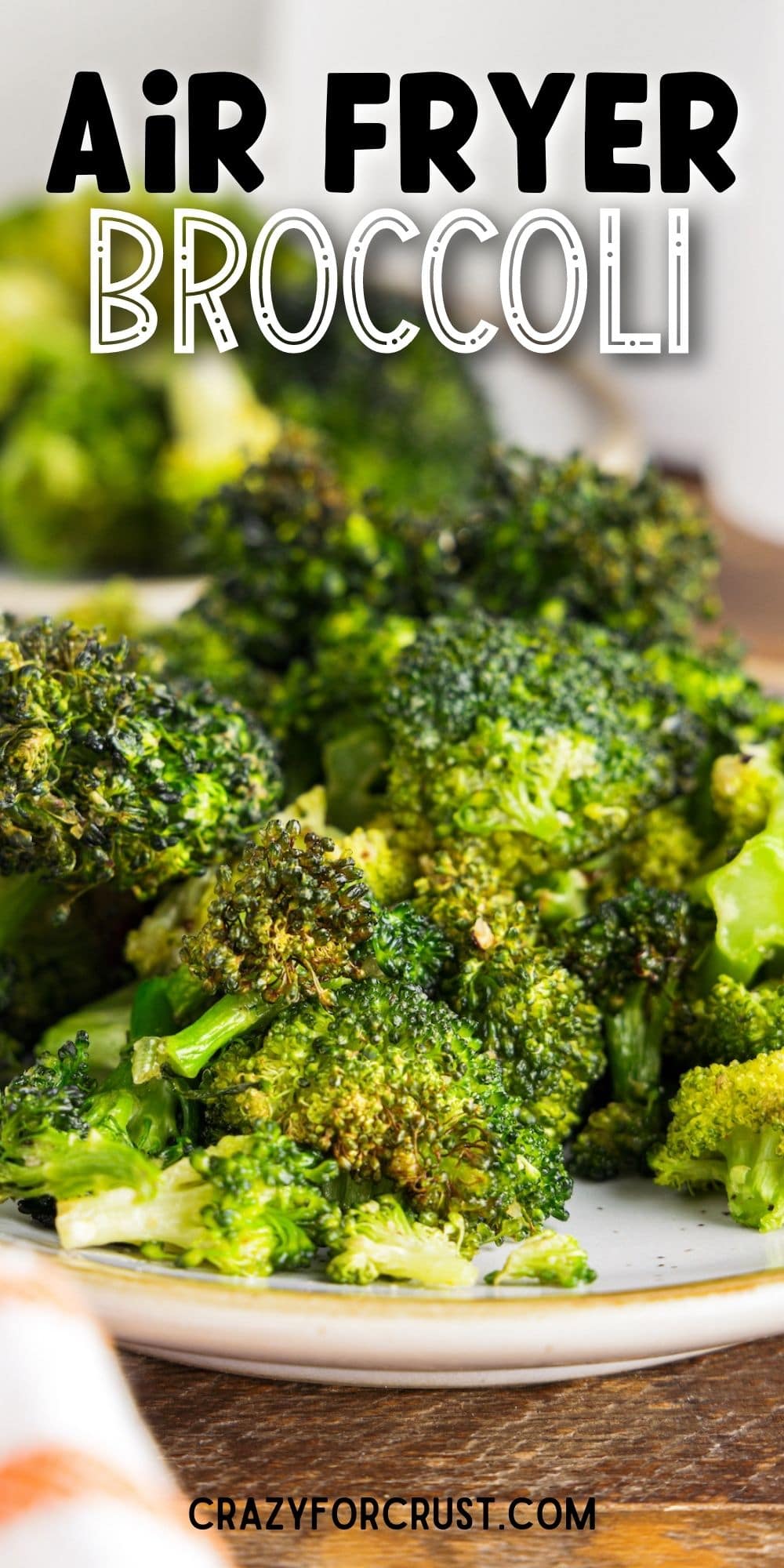 Plate full of air fryer broccoli with recipe title on top of image