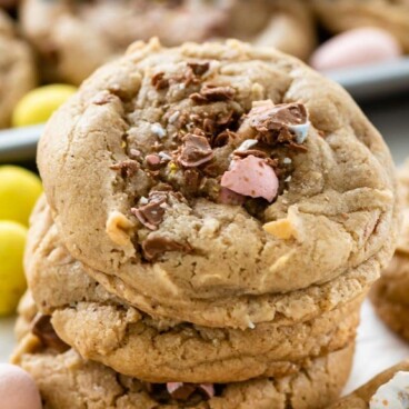 Overhead shot of cadbury egg cookies in a stack with recipe title on top of image