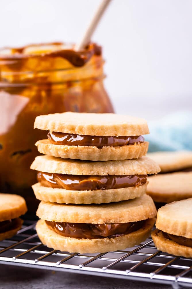 Three dulce de leche cookies stacked on top of eachother