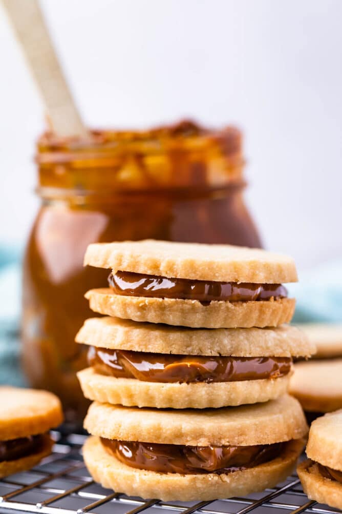 Three dulce de leche cookies stacked on top of eachother