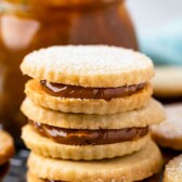 Three dulce de leche cookies stacked on top of eachother