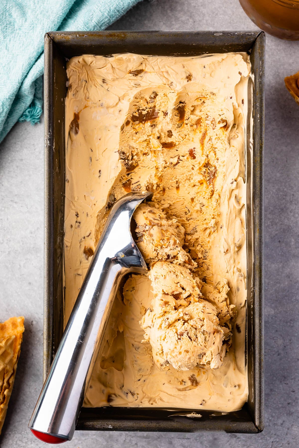 Overhead shot of dulce de leche ice cream with scoop