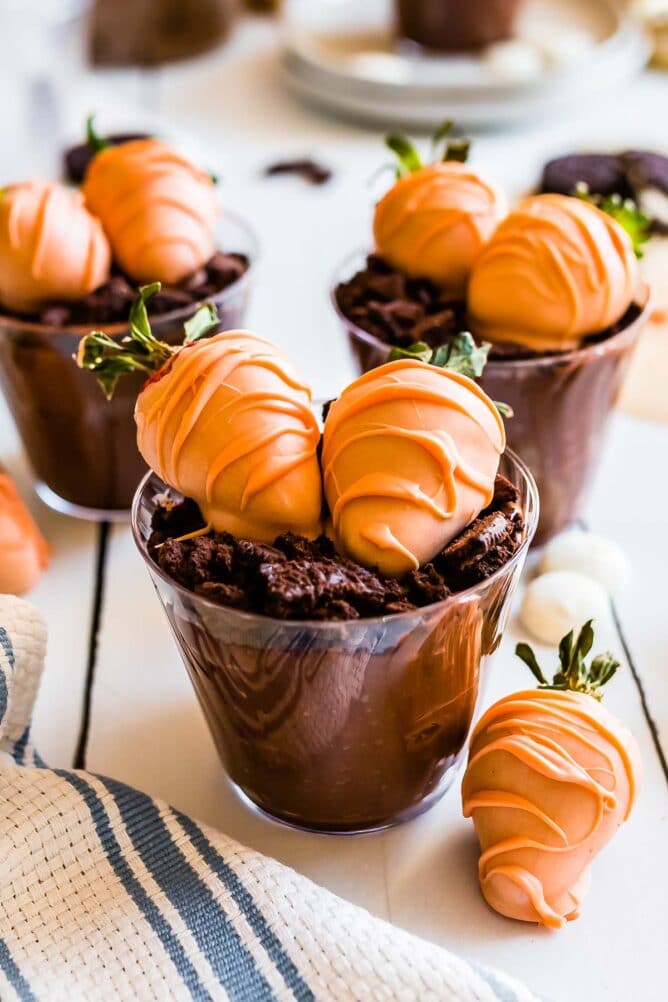 Easter dirt cups topped with chocolate covered strawberries