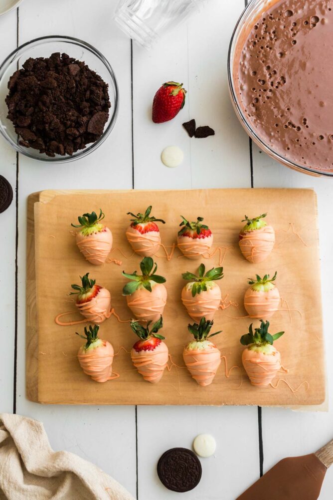 Overhead shot of chocolate covered strawberries on a cutting board