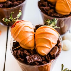 Easter dirt cups topped with chocolate covered strawberries