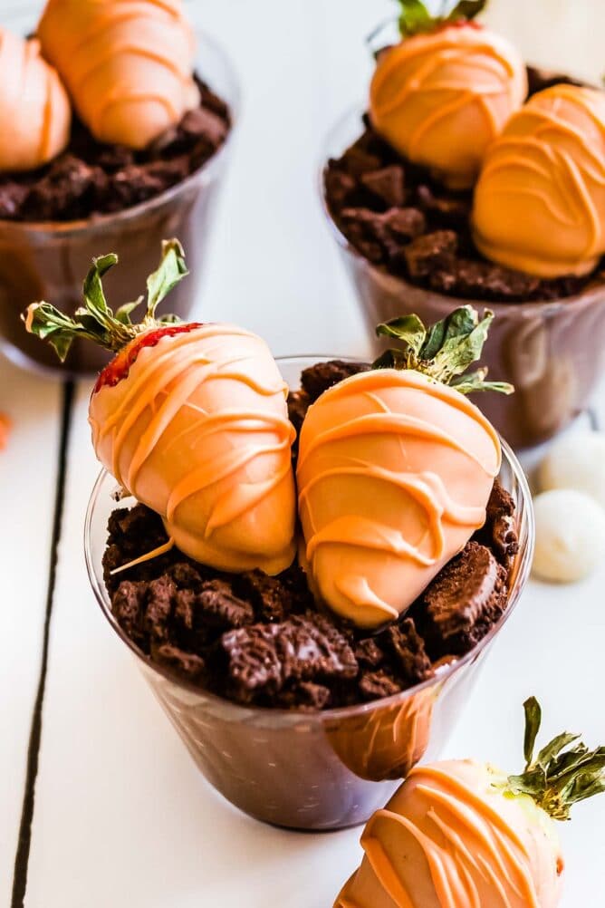 Easter dirt cups topped with chocolate covered strawberries