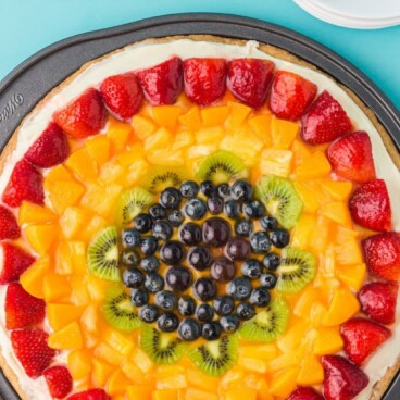 fruit pizza in pan on blue background