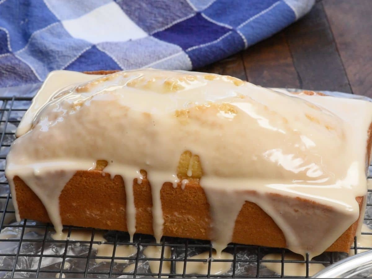 loaf cake on rack with drizzle.