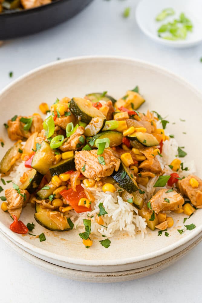 BBQ chicken skillet meal served on a plate with rice