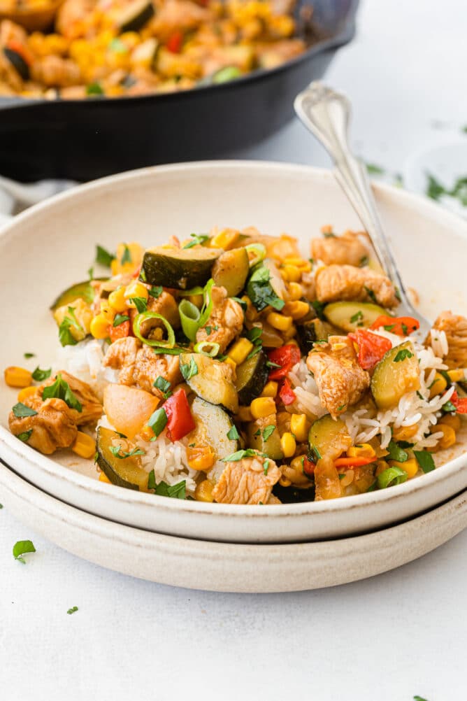 BBQ chicken skillet meal served on a plate with rice