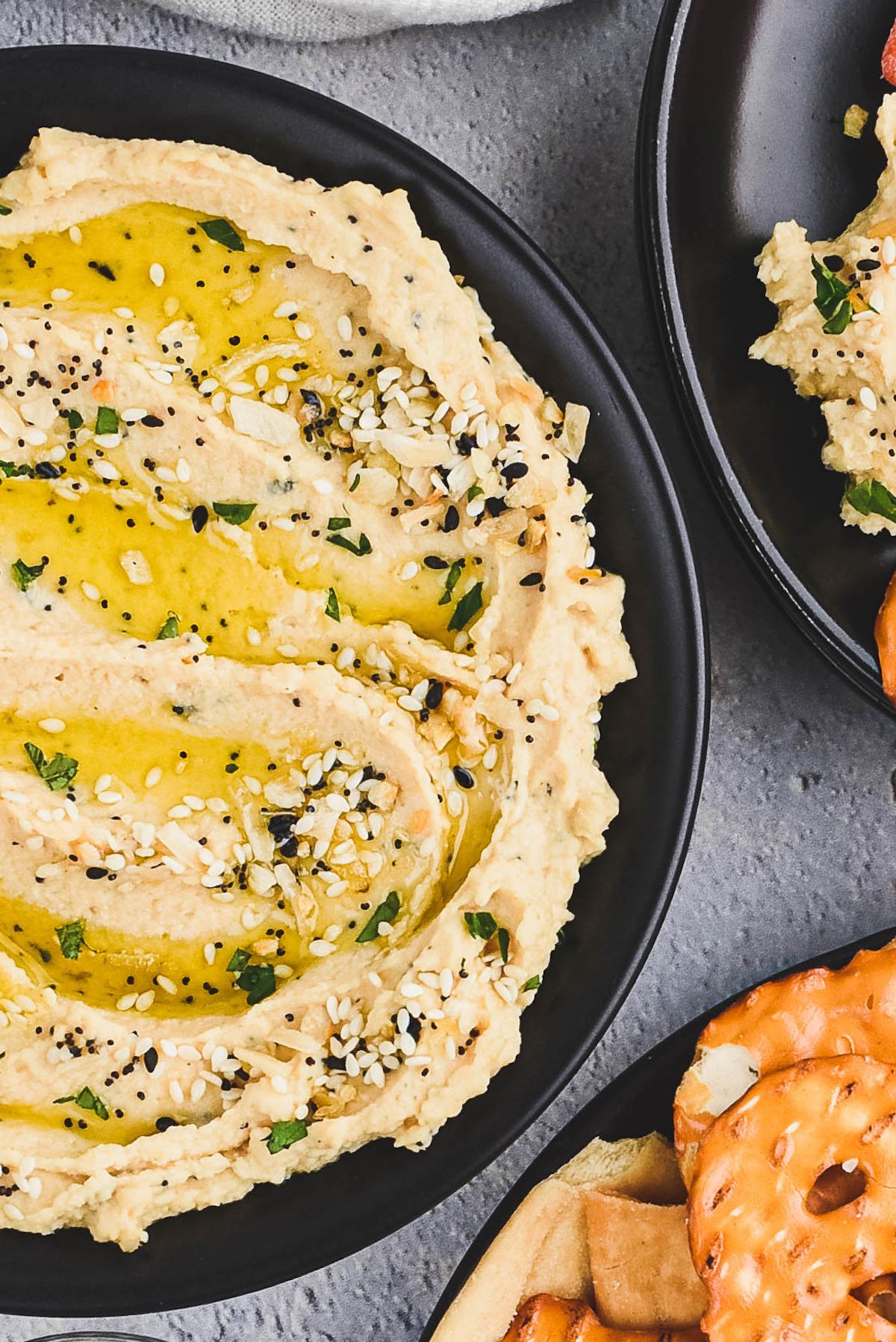 Close up shot of everything hummus in a black bowl