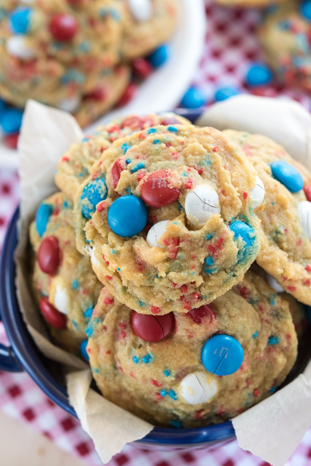 white plate with pile of cookies with red white and blue M&Ms