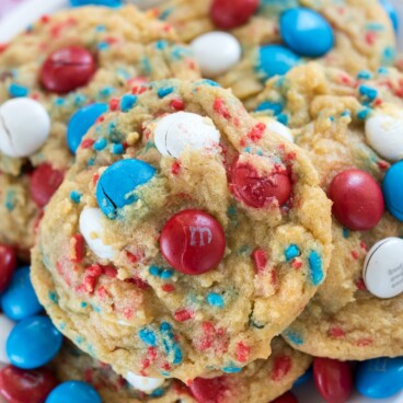 white plate with pile of cookies with red white and blue M&Ms