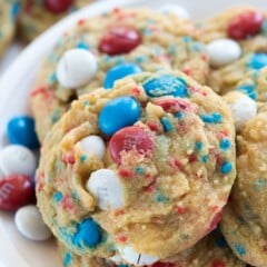 white plate with pile of cookies with red white and blue M&Ms