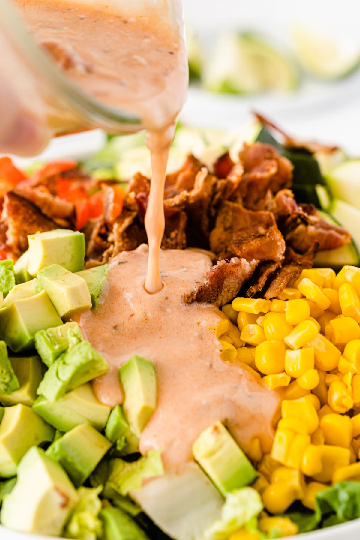 dressing pouring over salad